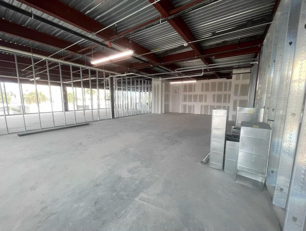 An unfinished commercial interior features metal wall studs, exposed ceiling beams, and concrete flooring — 1000 E Hallandale Beach Boulevard # 103, Hallandale Beach FL 33009, HALLANDALE BEACH, FL