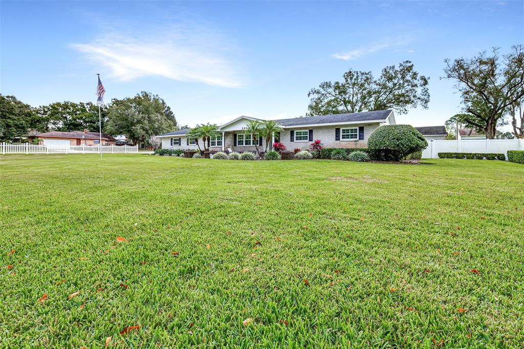 A single-story ranch-style house sits behind a large, expansive green lawn — 2404 GIBSONIA GALLOWAY ROAD, LAKELAND, FL