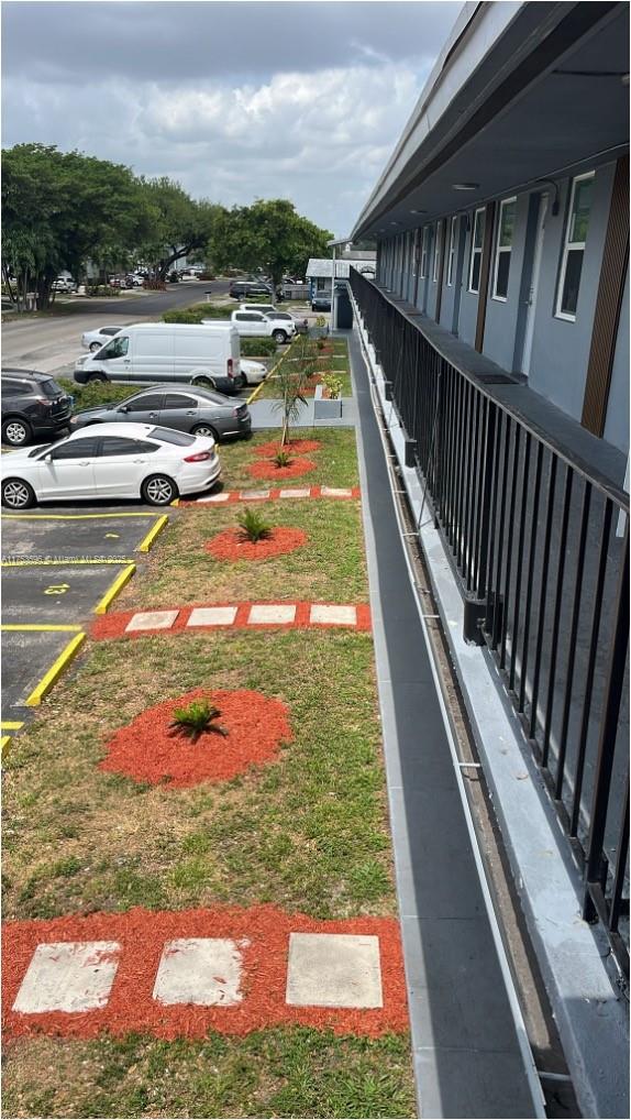 An exterior view of a multi-story building with a balcony overlooking a parking lot — 6051 Arthur St # 14, Hollywood FL 33024, HOLLYWOOD, FL
