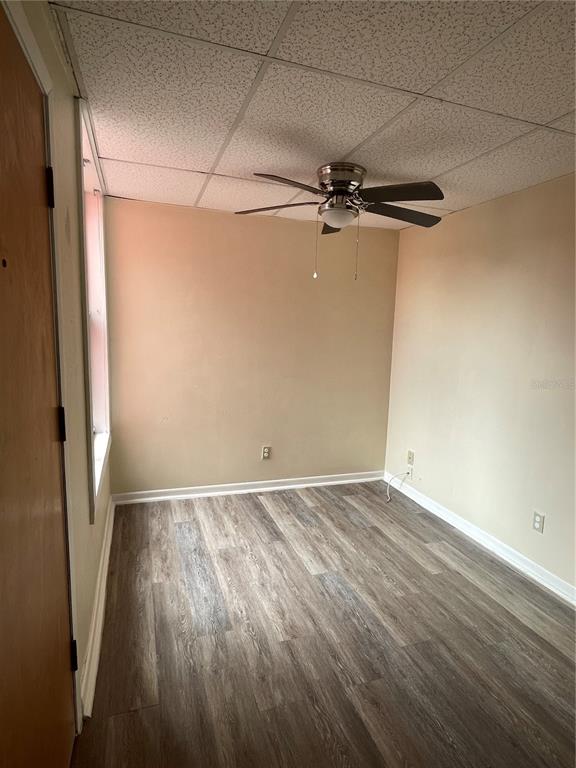 An empty room with beige walls, wood-look flooring, and a ceiling fan — 111 S NEWPORT AVENUE UNIT 18, TAMPA, FL