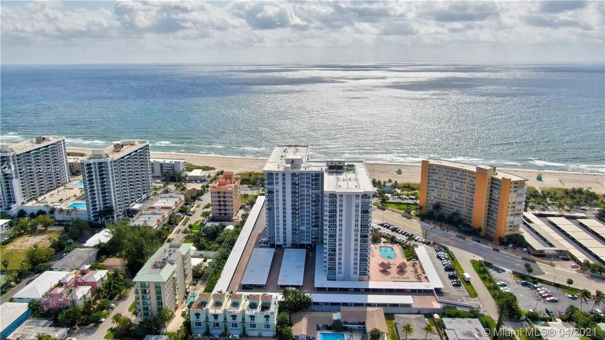 A spacious lobby features a curved patterned sofa, large white pillars, and polished tile floors — 405 N Ocean Boulevard # 1123, Pompano Beach FL 33062, POMPANO BEACH, FL