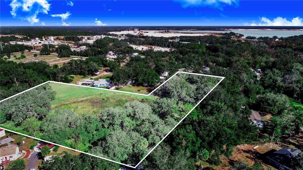 An aerial view shows a large, grassy, partially wooded lot outlined in white — US HIGHWAY 547 HIGHWAY, DAVENPORT, FL