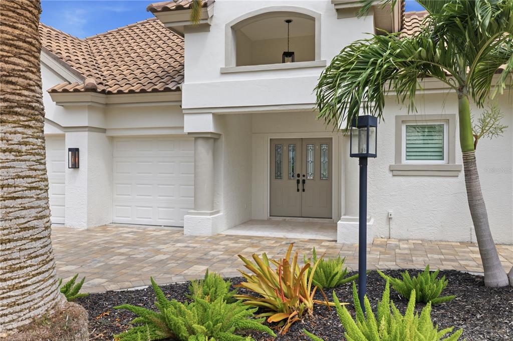 A single-story house with a tile roof, a palm tree, and a paved driveway — 309 S STONE BRIAR CREEK DRIVE, VENICE, FL