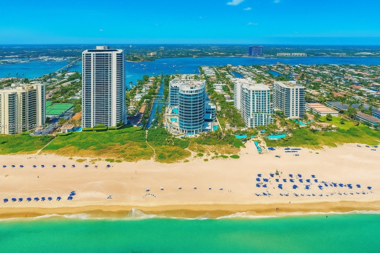 An aerial view of high-rise residential buildings situated along a sandy beach and ocean — 3100 N Ocean Drive # 1206, Singer Island FL 33404, SINGER ISLAND, FL
