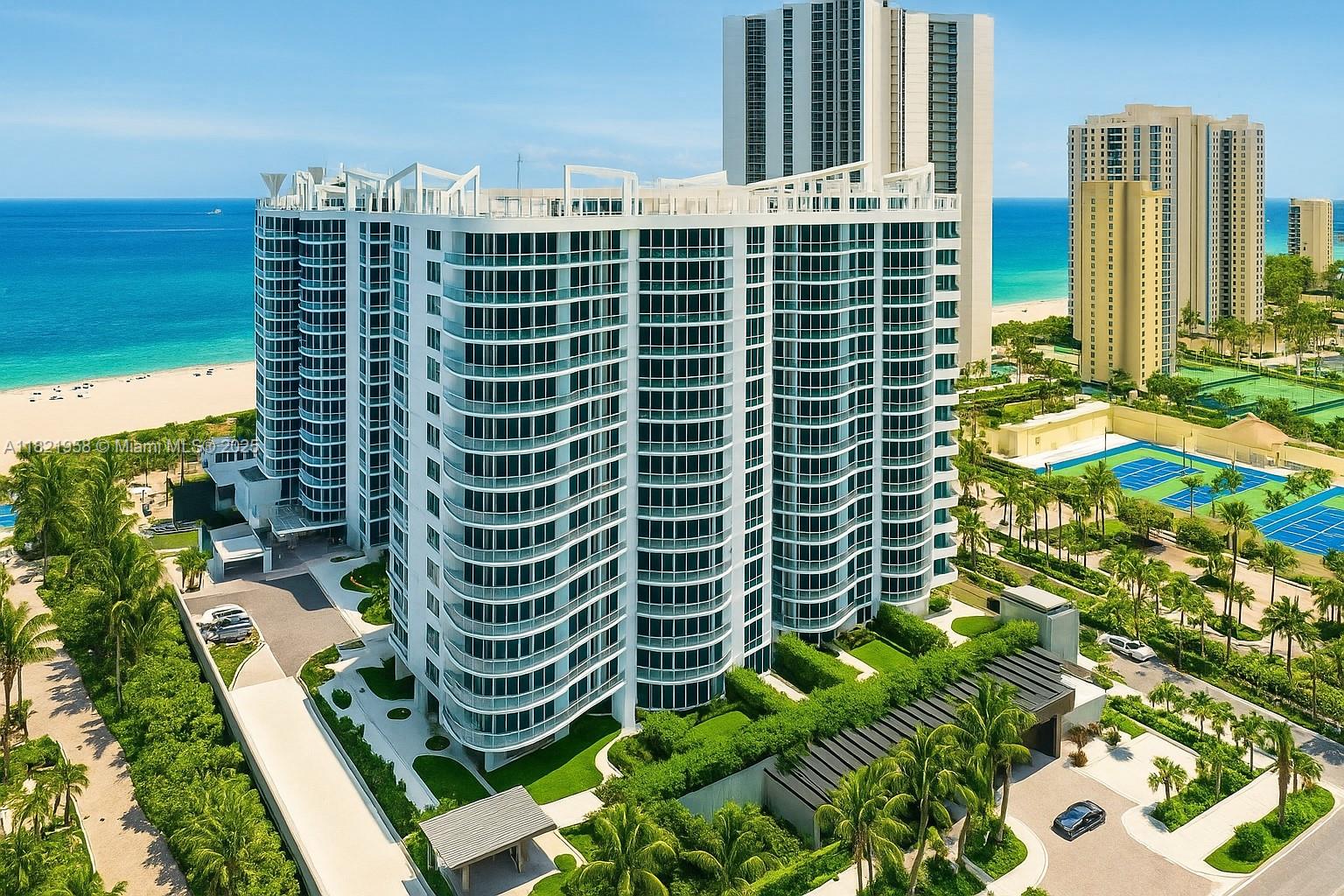 An aerial view of a modern white high-rise condominium building located near the ocean — 3100 N Ocean Drive # 1206, Singer Island FL 33404, SINGER ISLAND, FL