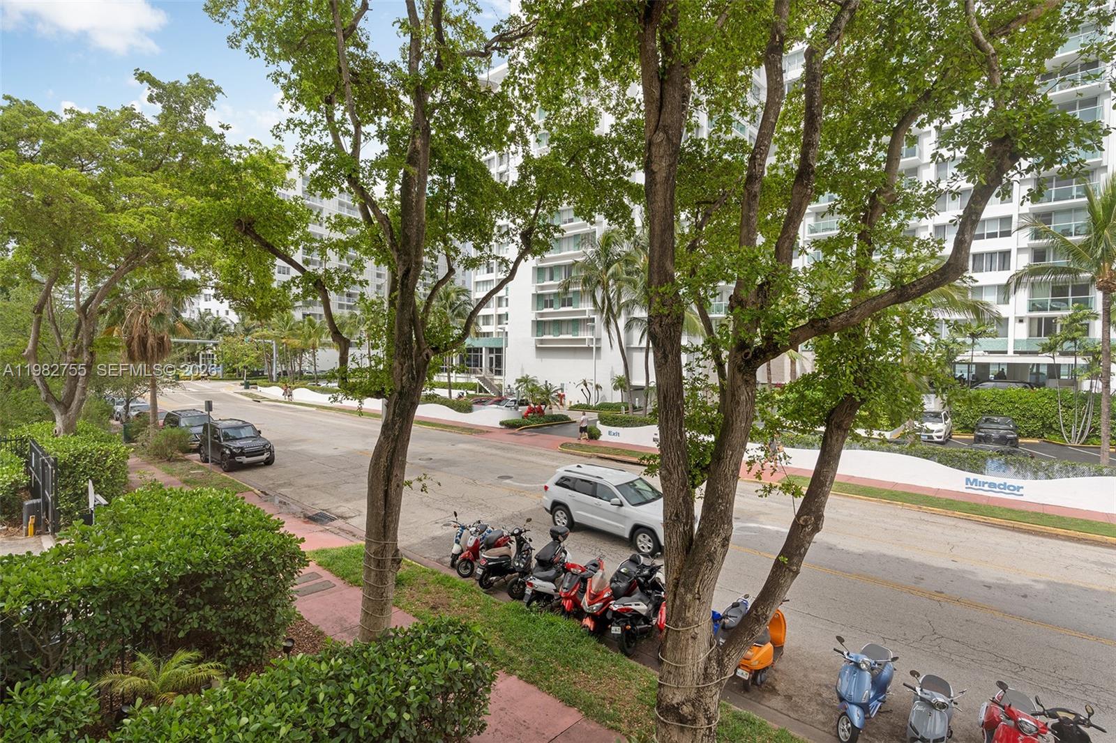An elevated view shows a street with parked scooters, cars, and a large white building — 1035 West Ave # 201, Miami Beach FL 33139, MIAMI BEACH, FL