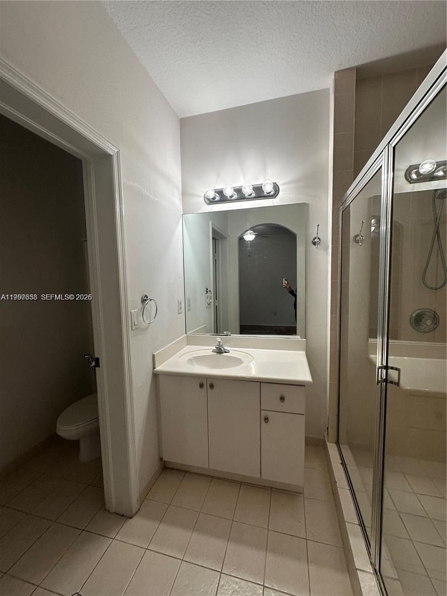 A bathroom features a white vanity, a mirror, a light fixture, and a glass shower — 2191 Anchor Ct # 1902, Dania Beach FL 33312, DANIA BEACH, FL