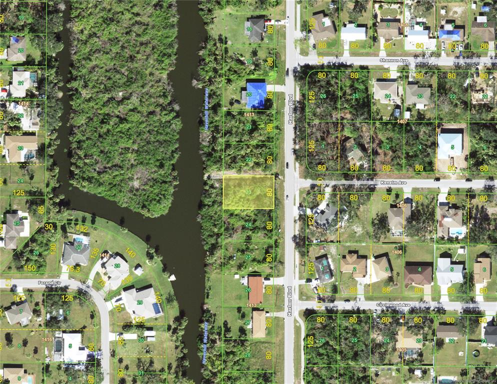 This is an aerial map showing a vacant lot highlighted in yellow along a waterway — 1457 HARBOR BOULEVARD, PORT CHARLOTTE, FL
