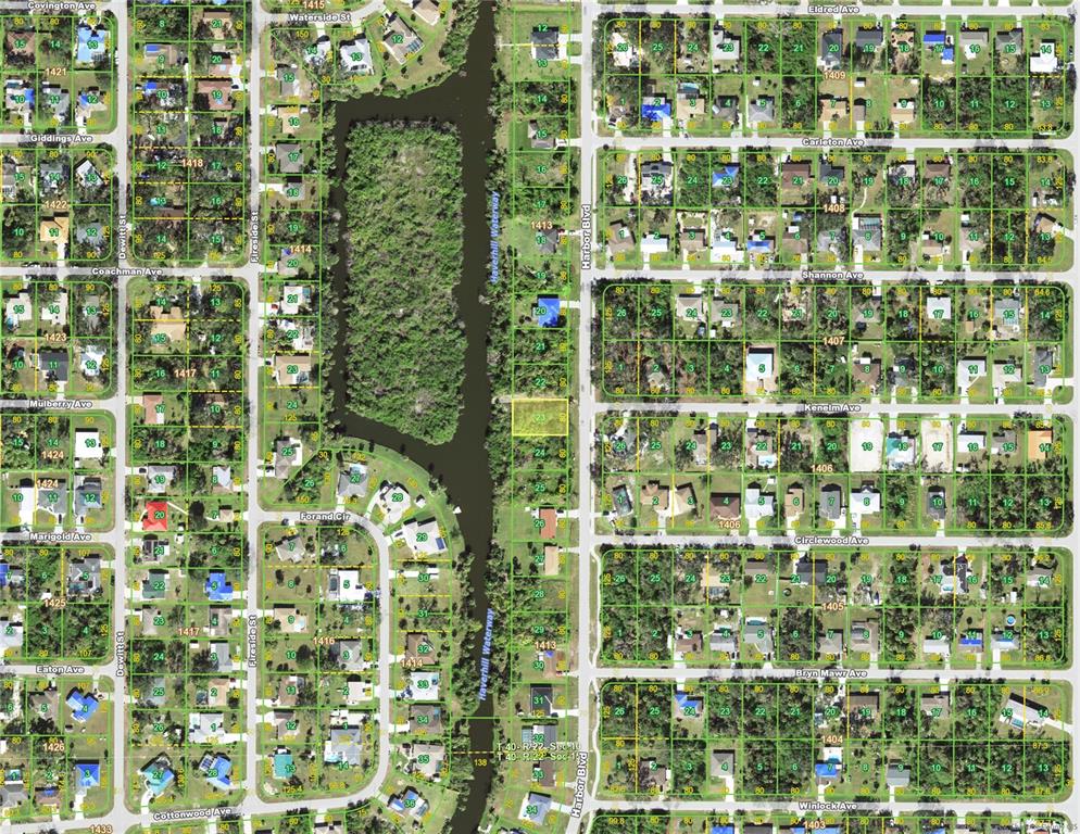 This is an aerial map showing residential lots and a waterway in a suburban neighborhood — 1457 HARBOR BOULEVARD, PORT CHARLOTTE, FL