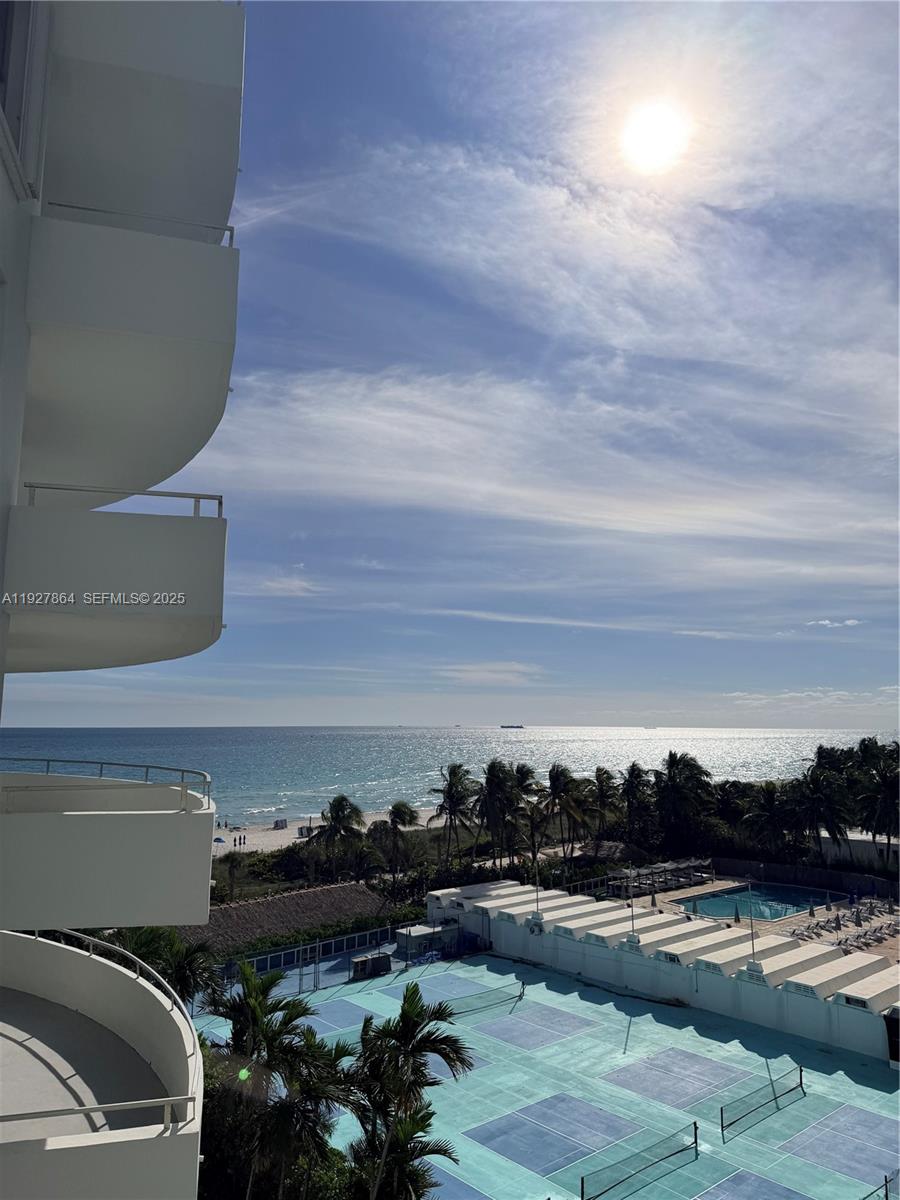 An elevated view shows a tennis court, a swimming pool, palm trees, and the ocean — 5151 Collins Ave, Miami Beach FL 33140, MIAMI BEACH, FL