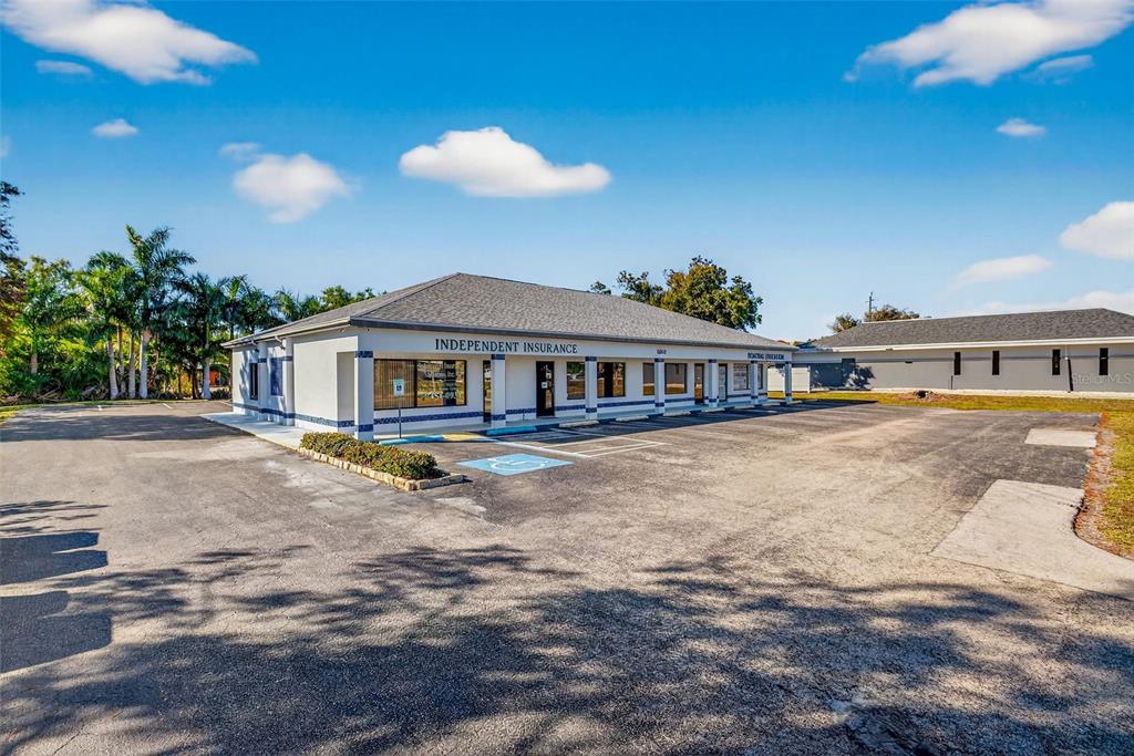 A single-story commercial building with a parking lot and an Independent Insurance sign — 16048 SAN CARLOS BOULEVARD, FORT MYERS, FL