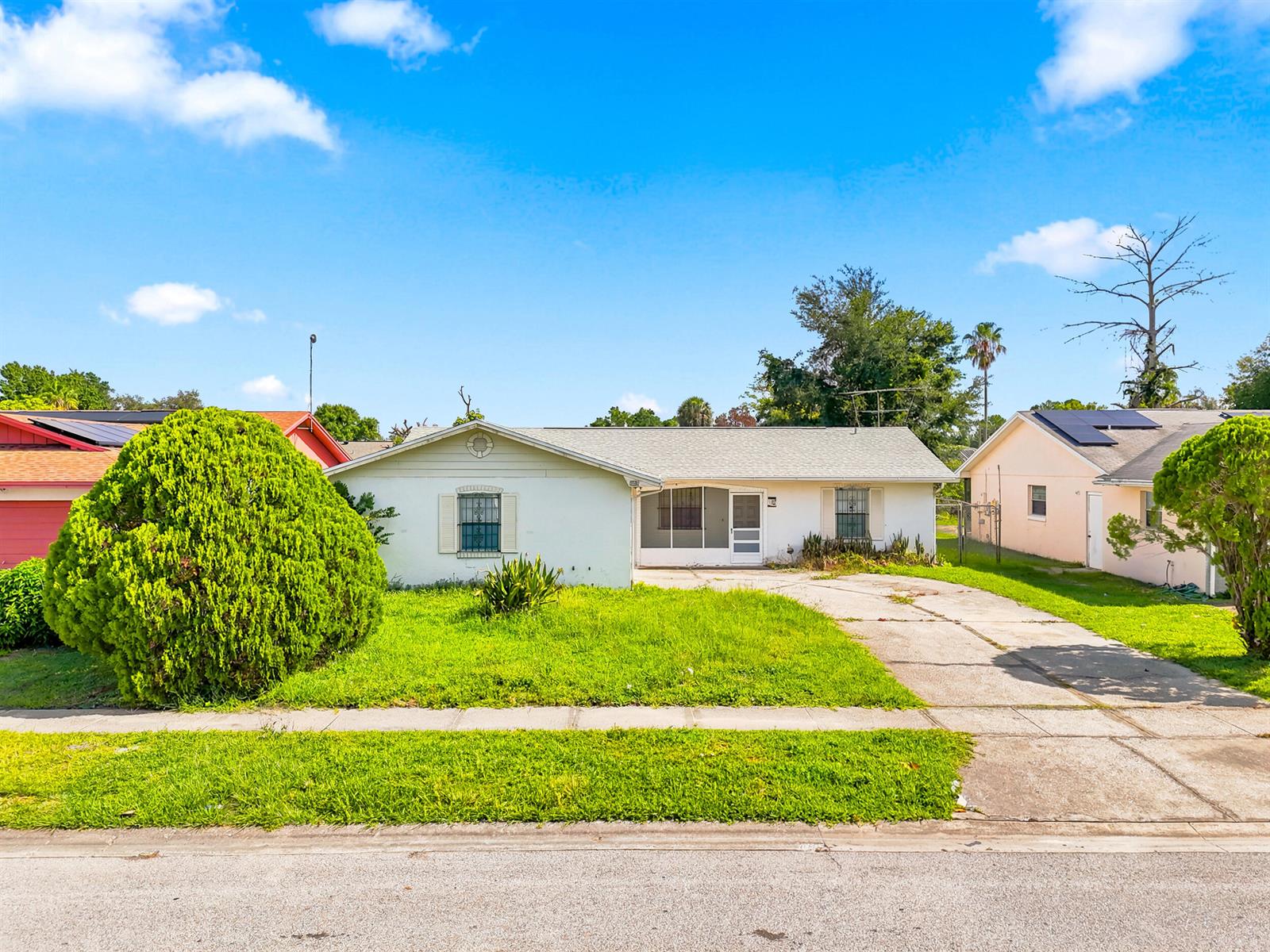 A single-story house with a white exterior, a concrete driveway, and a front lawn — 2737 Myakka Drive, Orlando FL 32839, ORLANDO, FL