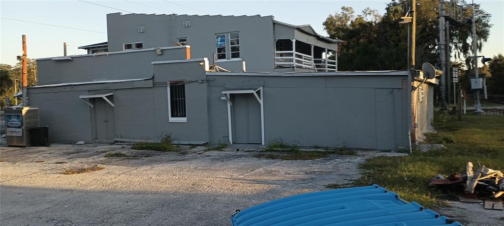 A gray, two-story concrete block building features two exterior doors and a second-story balcony — 1700 US HIGHWAY 17 N, SEVILLE, FL