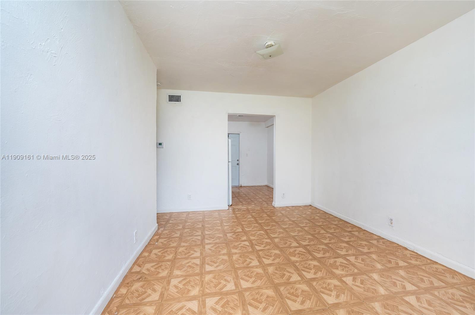 An empty room features white walls, a patterned vinyl floor, and a doorway leading elsewhere — 10015 SW 170th Ter, Miami FL 33157, MIAMI, FL