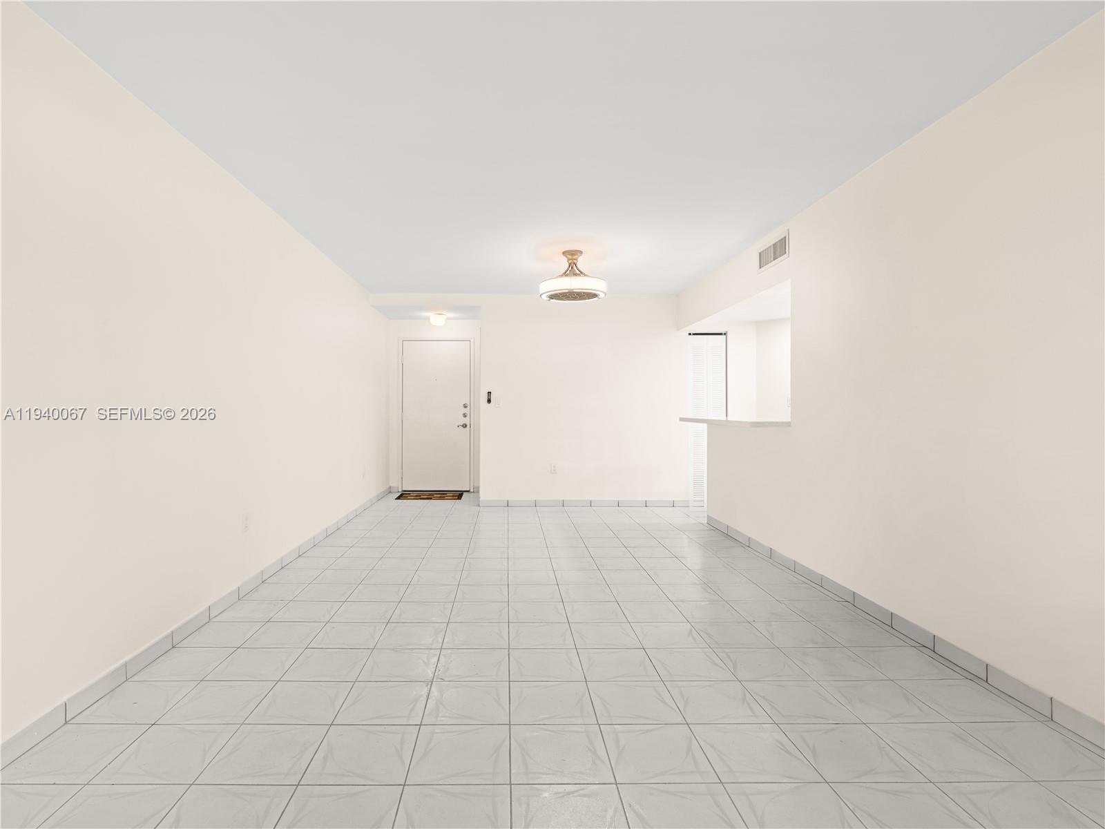 An empty room features white walls, light-colored tile flooring, and a ceiling fan — 10249 NW 9th St Cir # 8, Miami FL 33172, MIAMI, FL