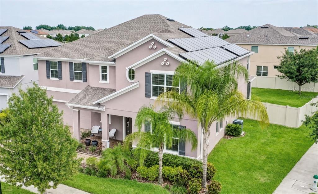 An exterior view of a two-story suburban house with solar panels on the roof — 14301 WHITE MOSS WAY, WINTER GARDEN, FL