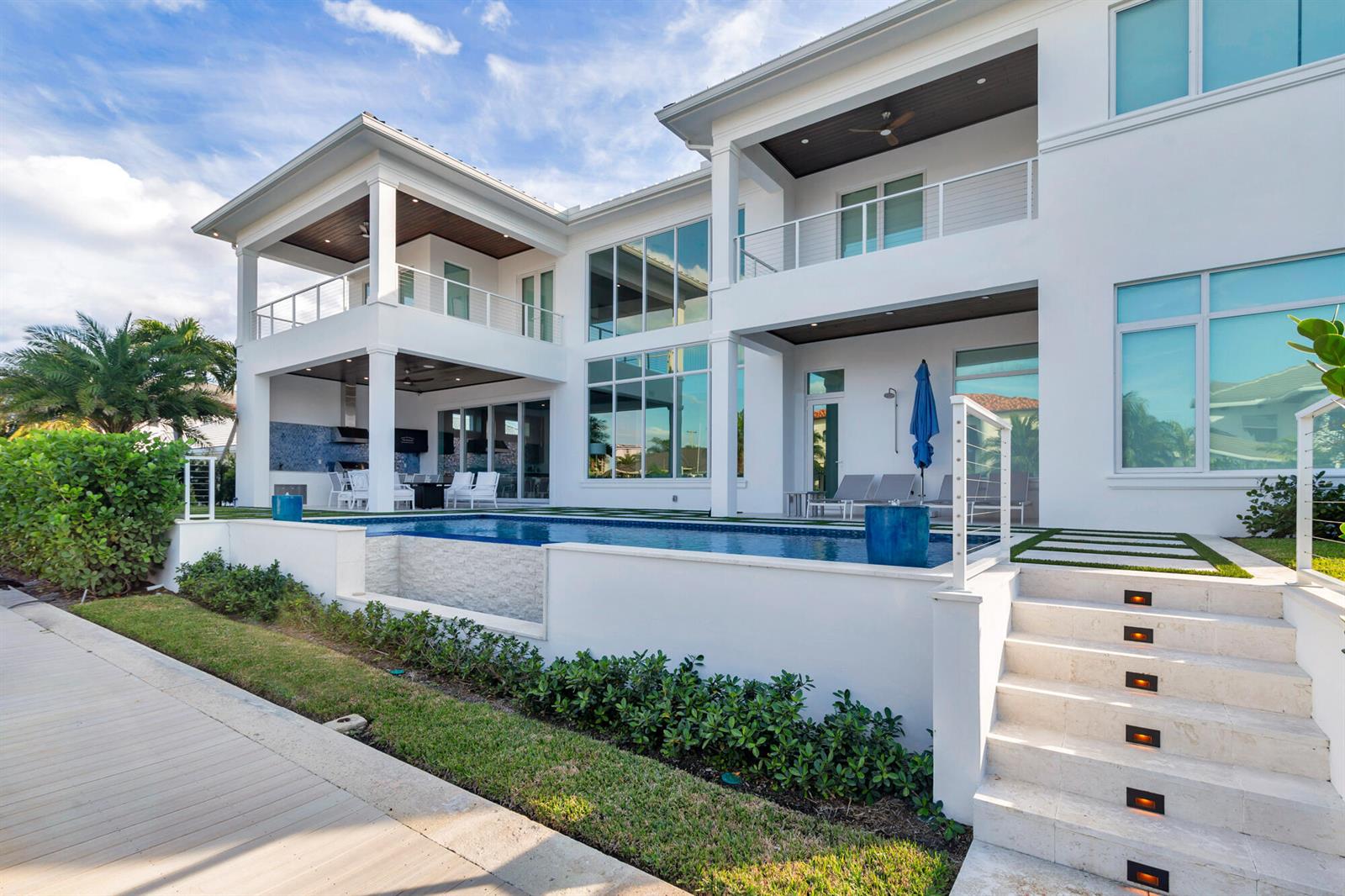 A modern two-story white house features a swimming pool, outdoor patio, and stone stairs — 1180 Bimini Lane, Singer Island FL 33404, SINGER ISLAND, FL