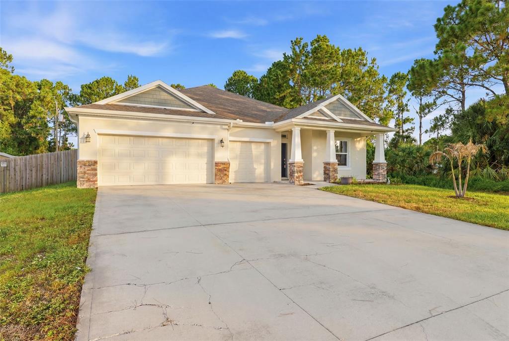 An aerial view shows a single-story house with a fenced backyard and surrounding trees — 242 HERITAGE ST STREET SW, PALM BAY, FL