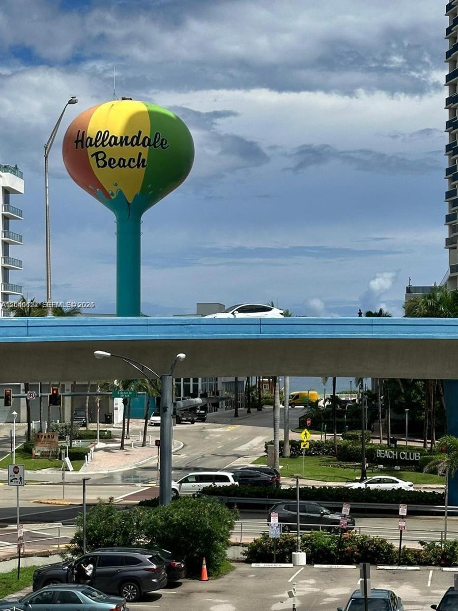 A view of a colorful Hallandale Beach water tower above a street and bridge — HALLANDALE BEACH, FL