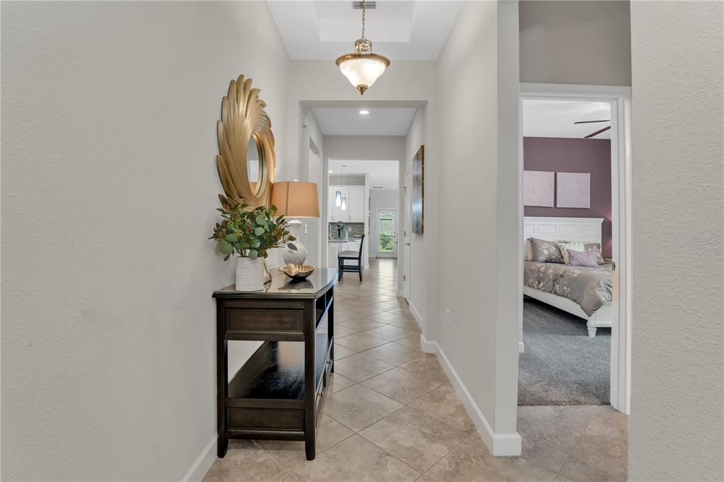 A tiled entryway leads to a hallway with a console table and a bedroom doorway — 1419 PRO SHOP CT, DAVENPORT, FL