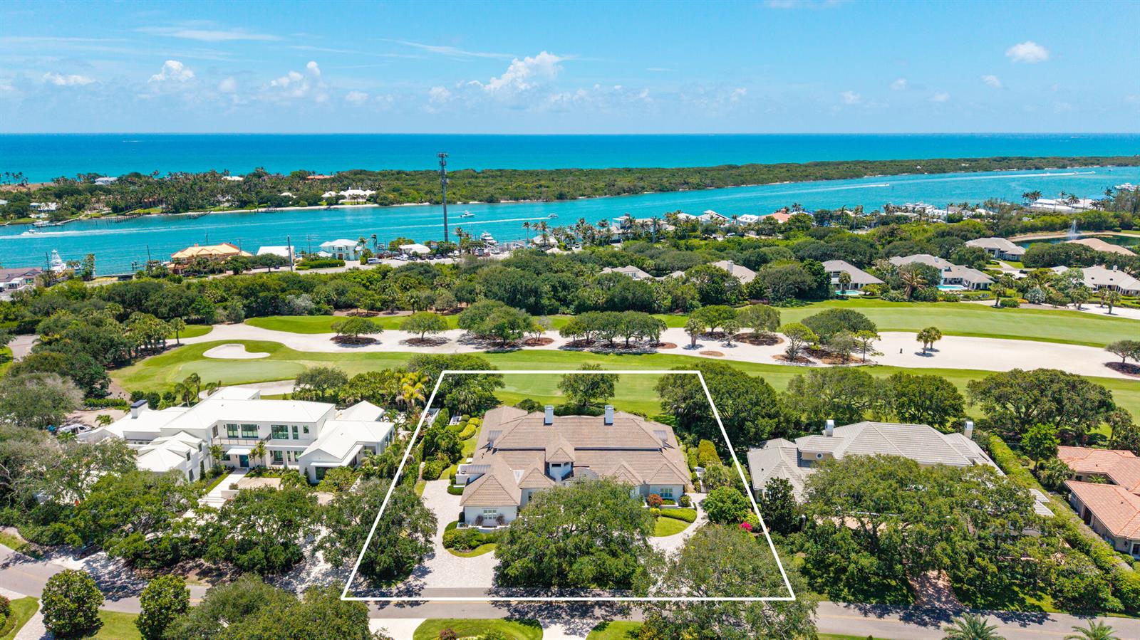 An aerial view shows a large house with a tiled roof surrounded by lush trees — 17965 SE Village Circle, Jupiter FL 33469, JUPITER, FL
