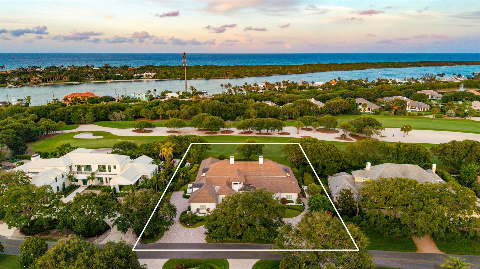 An aerial view shows a large house with a brown roof surrounded by trees and landscaping — 17965 SE Village Circle, Jupiter FL 33469, JUPITER, FL