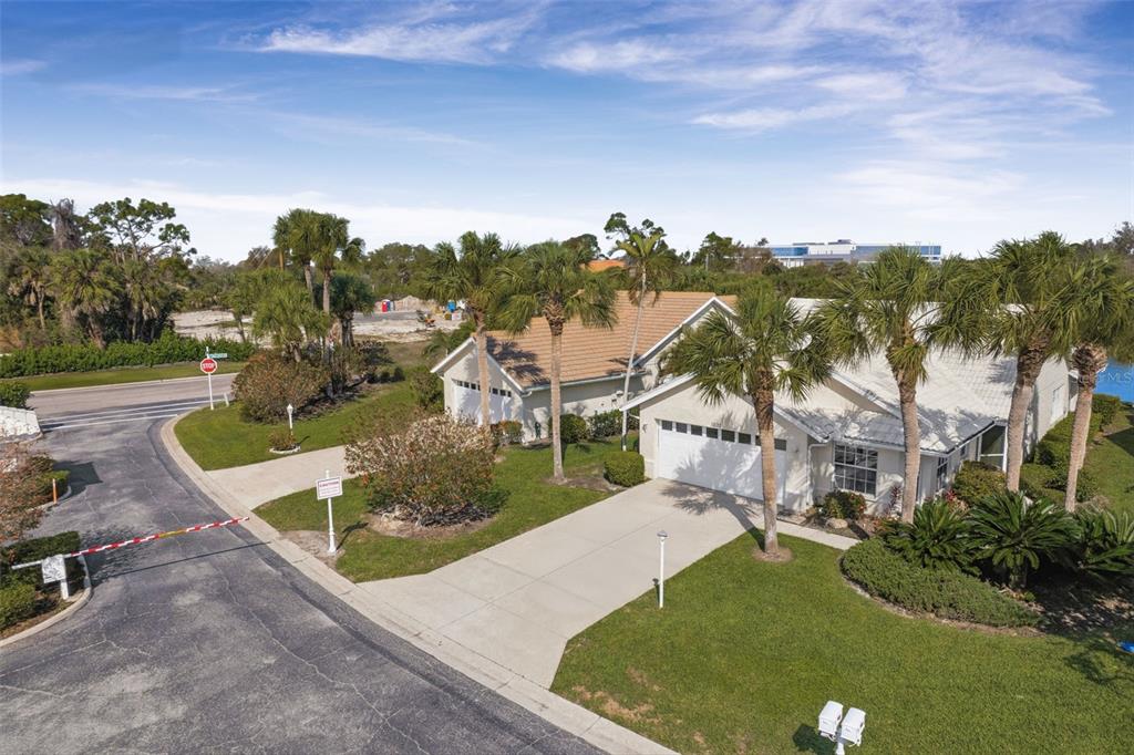 An aerial view of a single-story suburban house with a driveway and palm trees — 1803 ASHLEY DRIVE, VENICE, FL