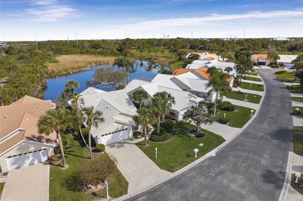 A single-story house with a two-car garage, palm trees, and a manicured lawn — 1803 ASHLEY DRIVE, VENICE, FL