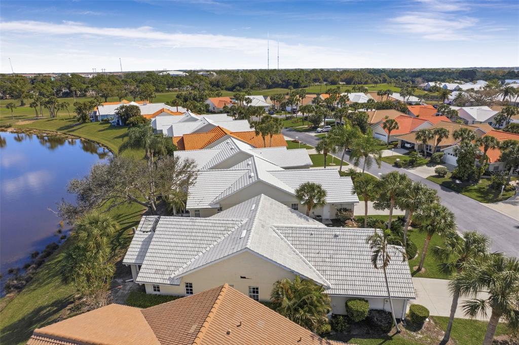 The exterior of a single-story house features a white garage door and a concrete driveway — 1803 ASHLEY DRIVE, VENICE, FL
