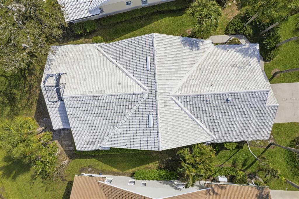 A single-story house with a white garage door and a concrete driveway at dusk — 1803 ASHLEY DRIVE, VENICE, FL