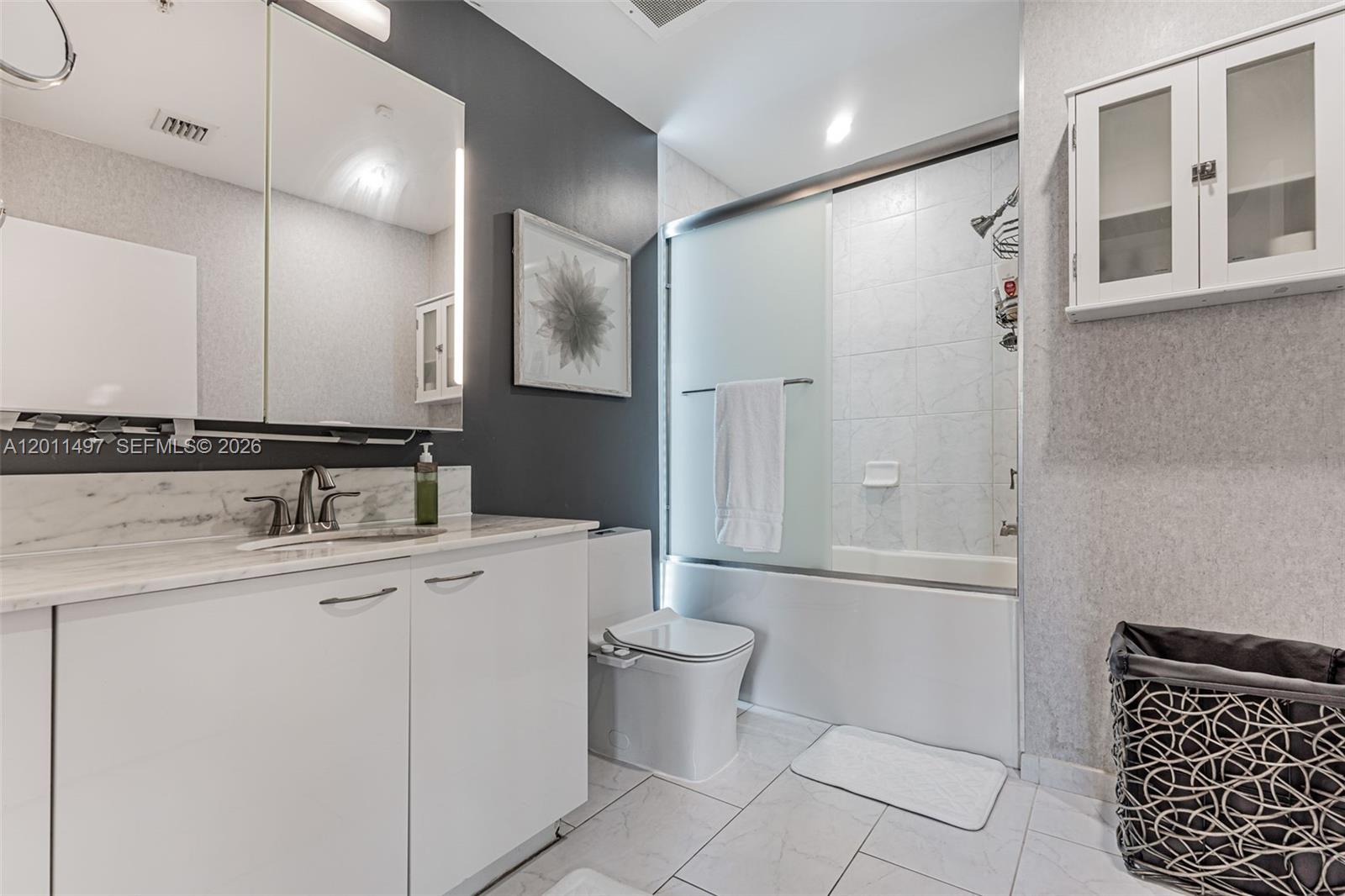 A modern bathroom features a white vanity, a toilet with a bidet, and a tub-shower — 133 NE 2nd Ave # 1208, Miami FL 33132, MIAMI, FL