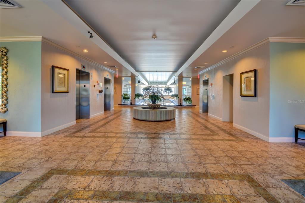 A spacious lobby features tiled floors, two sets of elevators, and a central circular seating area — 2937 S ATLANTIC AVENUE UNIT 2008, DAYTONA BEACH SHORES, FL
