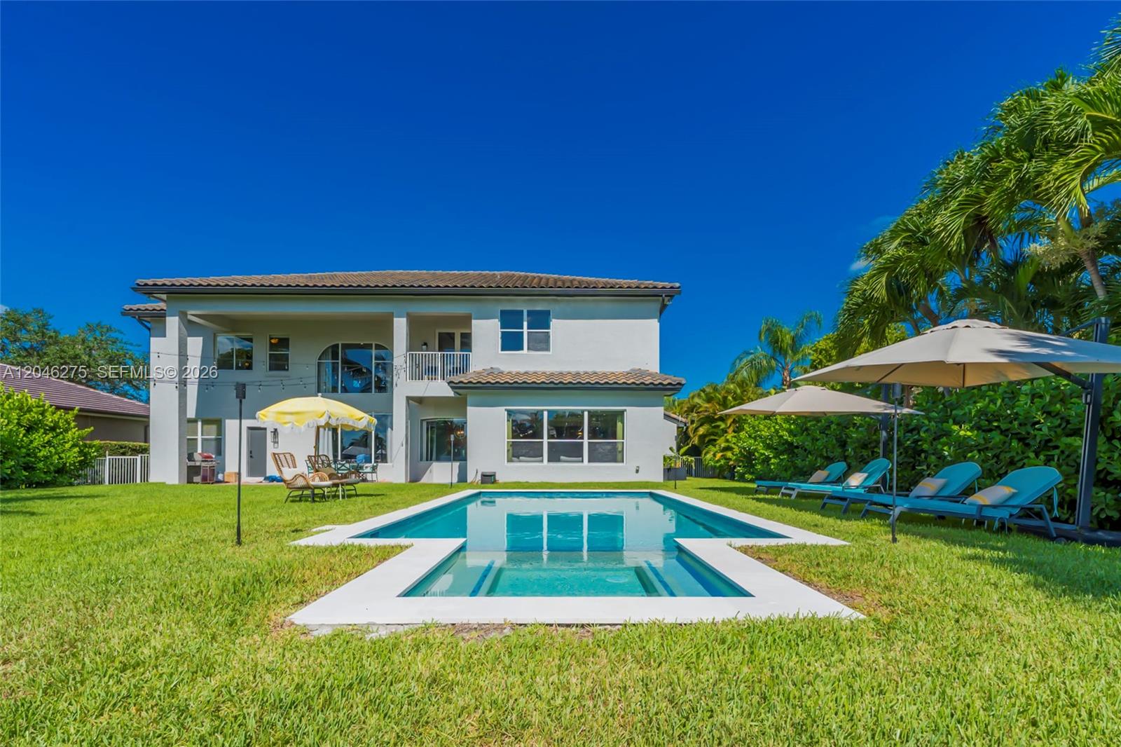 A two-story house features a backyard with a swimming pool and lounge chairs — 4135 SW 186th Way, Miramar FL 33029, MIRAMAR, FL