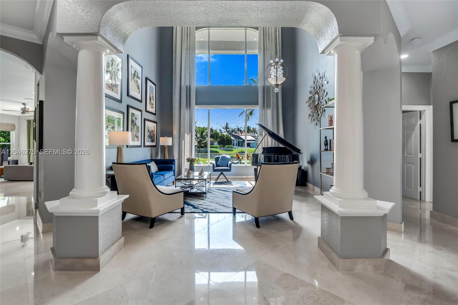 A living room features a grand piano, two-story windows, and columns framing the space — 4135 SW 186th Way, Miramar FL 33029, MIRAMAR, FL
