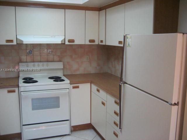 A kitchen features white cabinets, a white electric stove, and a white refrigerator — 9022 SW 123rd Ct # O303, Miami FL 33186, MIAMI, FL