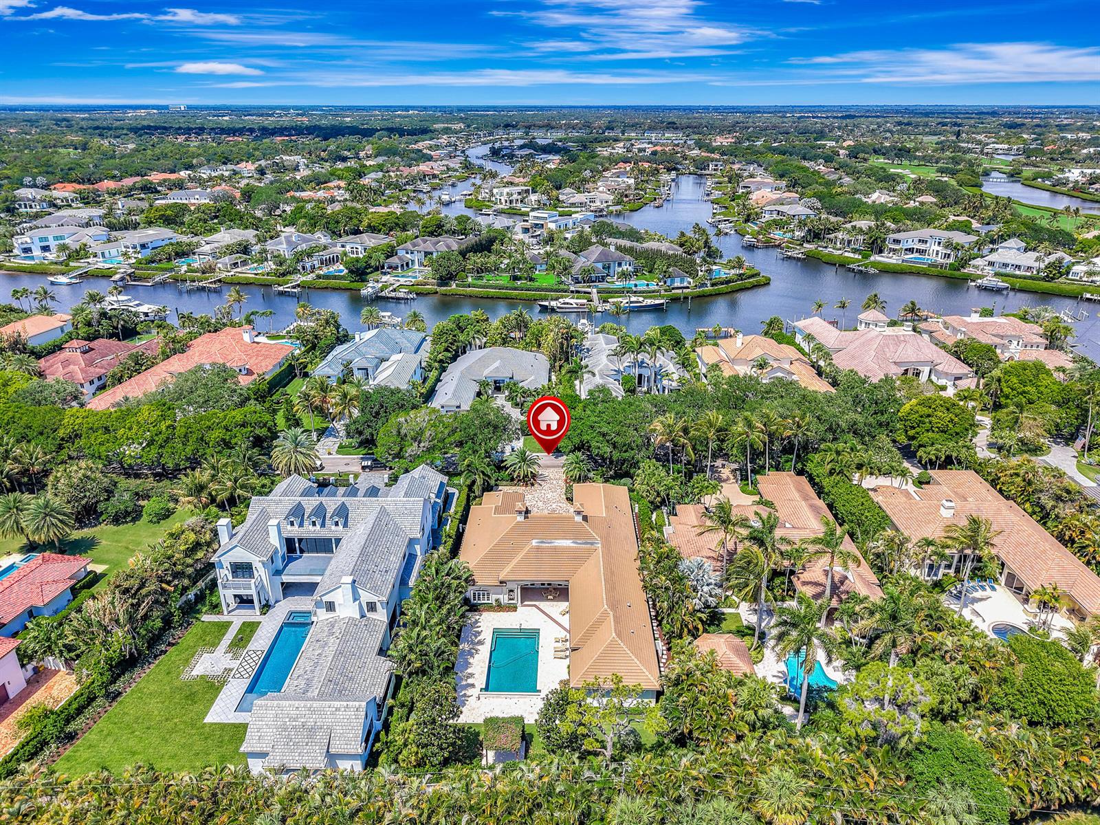 An aerial view shows a large house with a swimming pool and a red marker — 469 Mariner Drive, Jupiter FL 33477, JUPITER, FL