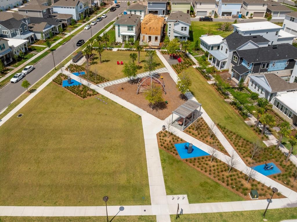 An aerial view shows a neighborhood park with walking paths, playground equipment, and surrounding houses — 10584 PEARSON AVENUE, ORLANDO, FL