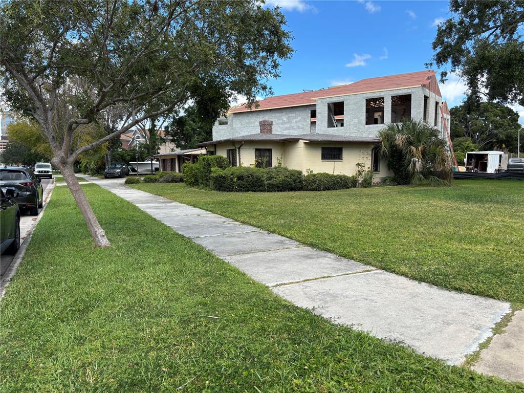 A single-story house with a large, unfinished two-story concrete block addition under construction — 61 ADALIA AVENUE, TAMPA, FL