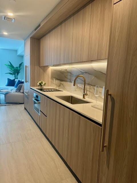 An open-concept living area features a kitchen, dining space, and a balcony with city views — 77 SE 5th St # 2708, Miami FL 33131, MIAMI, FL
