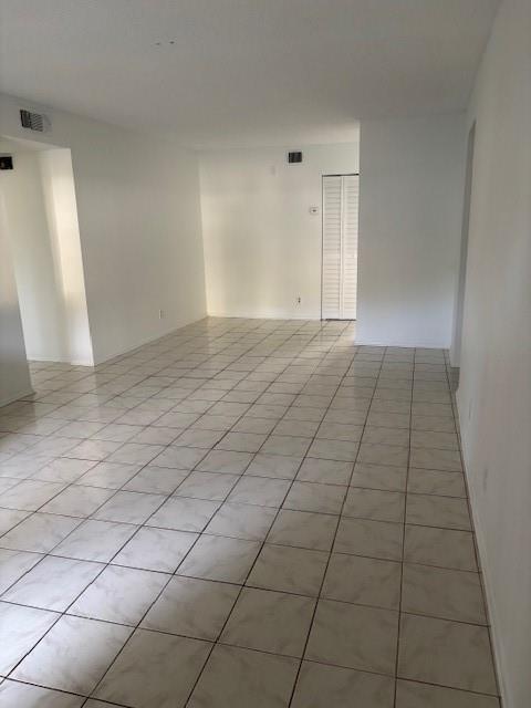 An empty room with white walls and light-colored square floor tiles — 501 Gardens Drive # 101, Pompano Beach FL 33069, POMPANO BEACH, FL