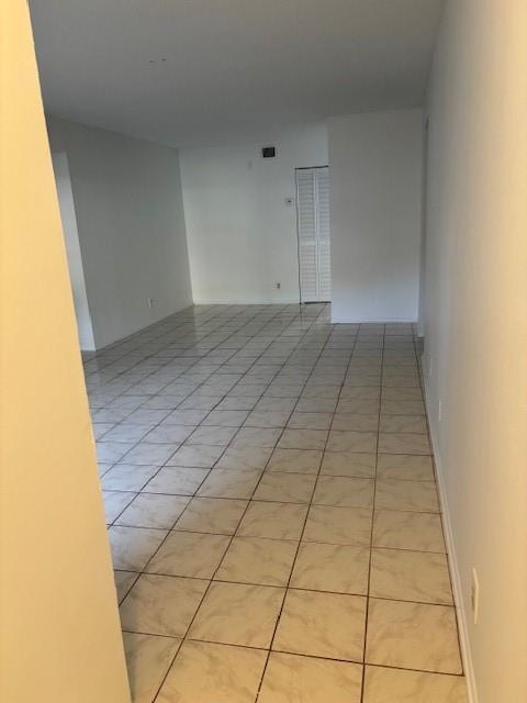 An empty room with light-colored square floor tiles and white walls — 501 Gardens Drive # 101, Pompano Beach FL 33069, POMPANO BEACH, FL
