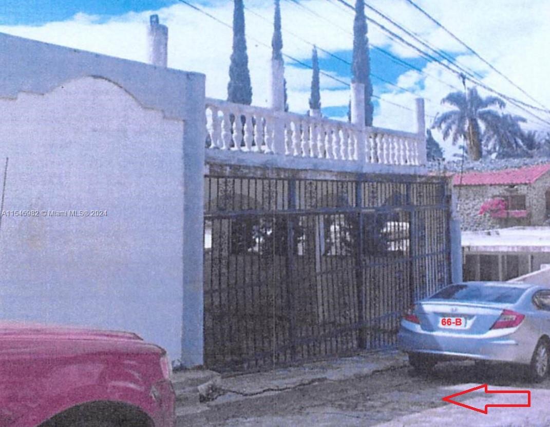 A silver sedan is parked in front of a house with a gated entrance — 66-B ARROYO HONDO VIEJO DN, 0 0, 0