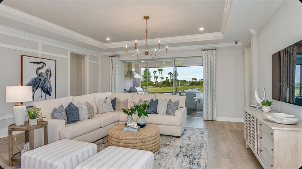 A living room features a sectional sofa, round coffee table, and sliding doors to a patio — 109 ARMOYAN DRIVE, PALM COAST, FL