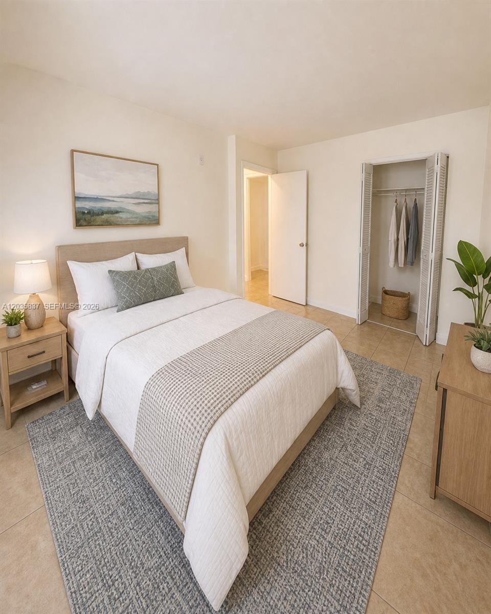 A bedroom features a bed, a nightstand, a closet, and tile flooring — 1533 NW 2nd Ave # 6, Miami FL 33136, MIAMI, FL