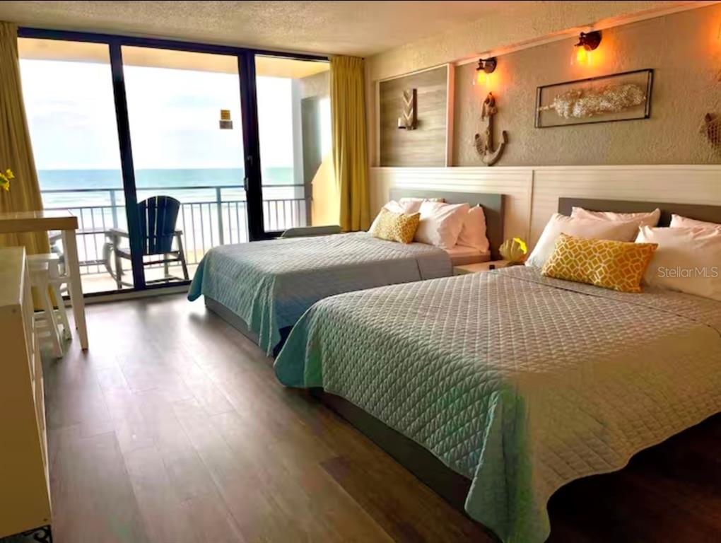 A hotel room with two beds, nautical decor, and a balcony overlooking the ocean — 2301 S ATLANTIC AVENUE UNIT 337, DAYTONA BEACH, FL