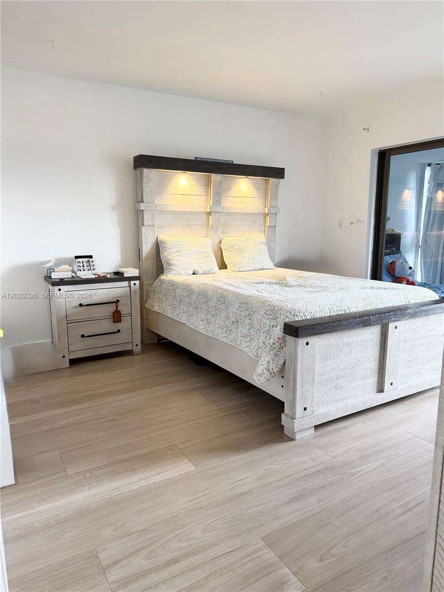 A bedroom features a rustic white wooden bed frame with integrated lighting and light flooring — 8101 SW 24th Ct # 405, Davie FL 33324, DAVIE, FL