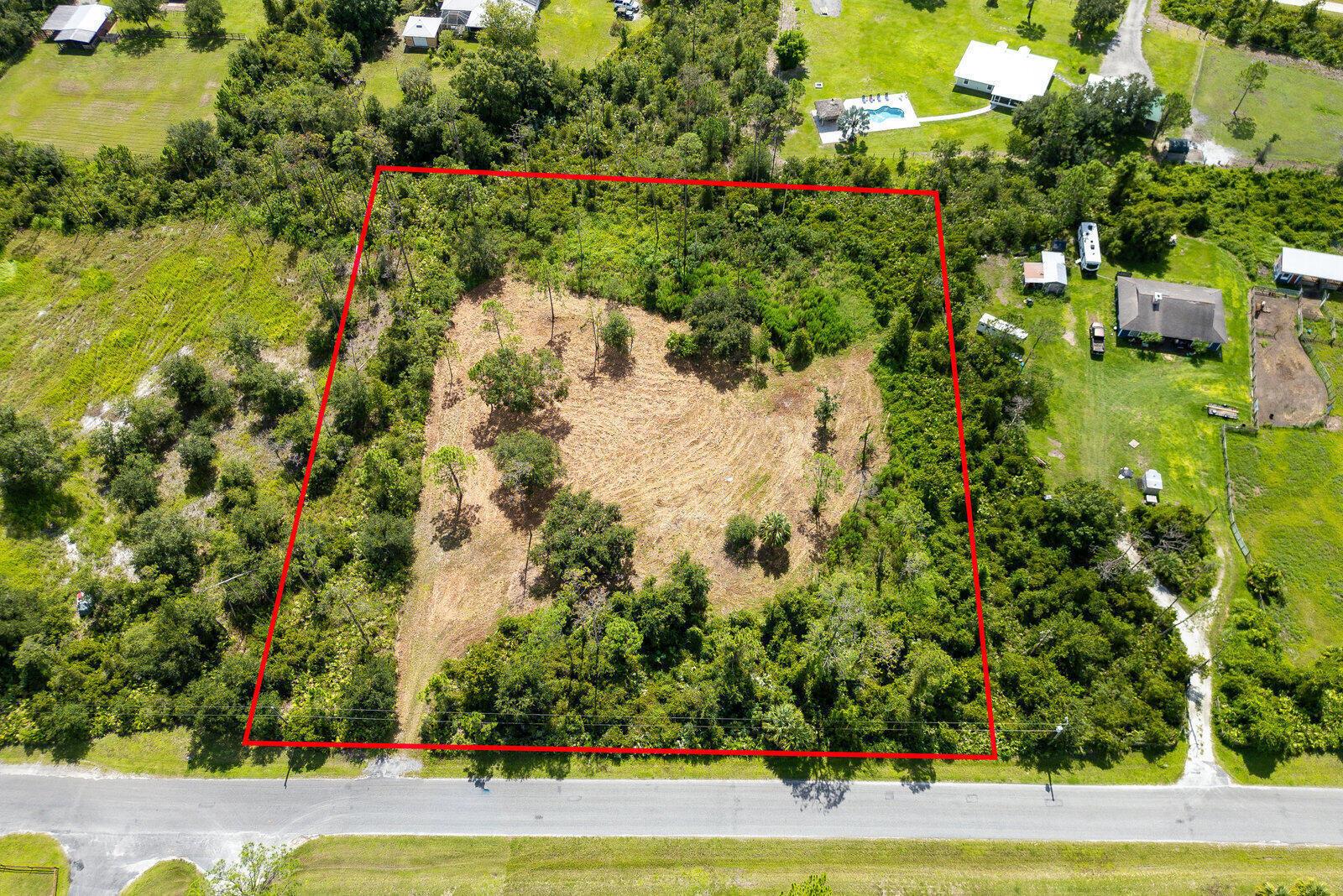 An aerial view shows a rectangular, partially cleared plot of land bordered by a road — 32801 Us Highway 441 N, Okeechobee FL 34972, OKEECHOBEE, FL