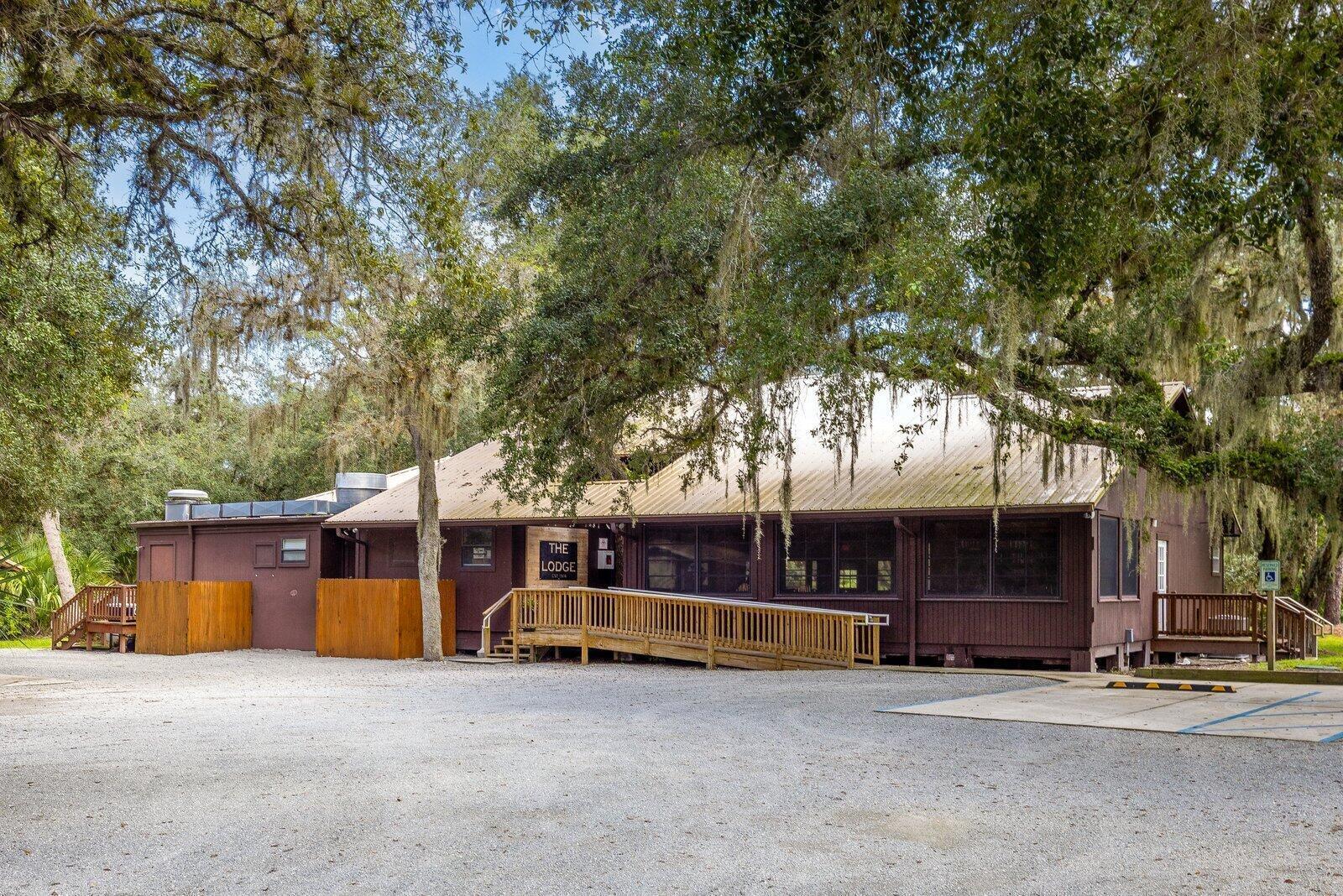 A brown wooden building with a metal roof and a wooden wheelchair ramp — 32801 Us Highway 441 N, Okeechobee FL 34972, OKEECHOBEE, FL