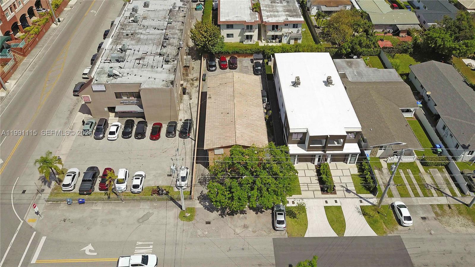 An aerial view shows a commercial building with a parking lot and adjacent residential properties — 3191 SW 23rd St, Miami FL 33145, MIAMI, FL