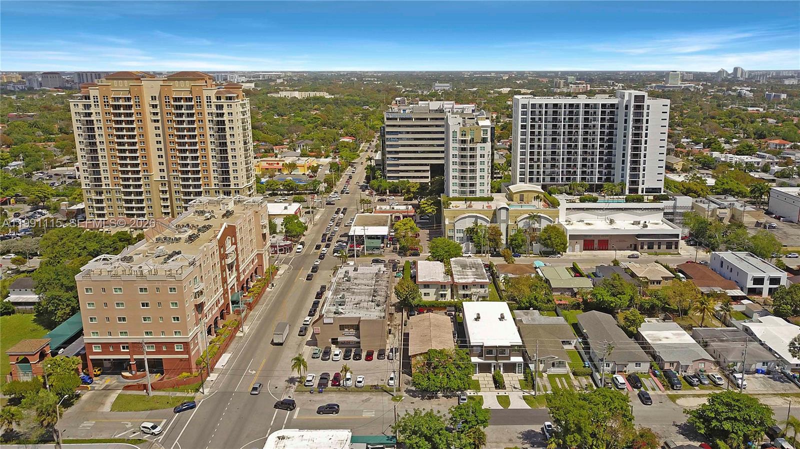 An aerial view shows a city street lined with mid-rise buildings, parking lots, and trees — 3191 SW 23rd St, Miami FL 33145, MIAMI, FL